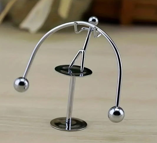 The cradle of Newton's pendulum. Creative Balance Iron Man. A gift for a child on a desk